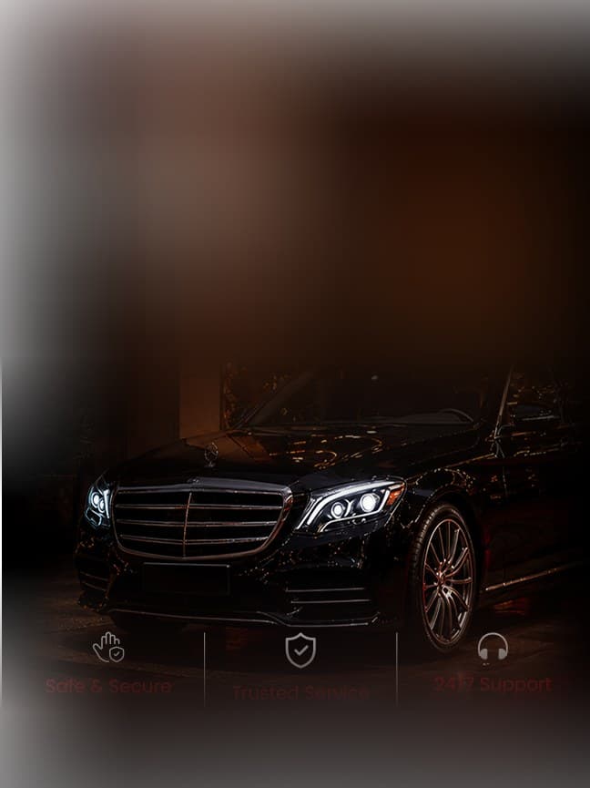 Black luxury chauffeur car at a hotel entrance at night